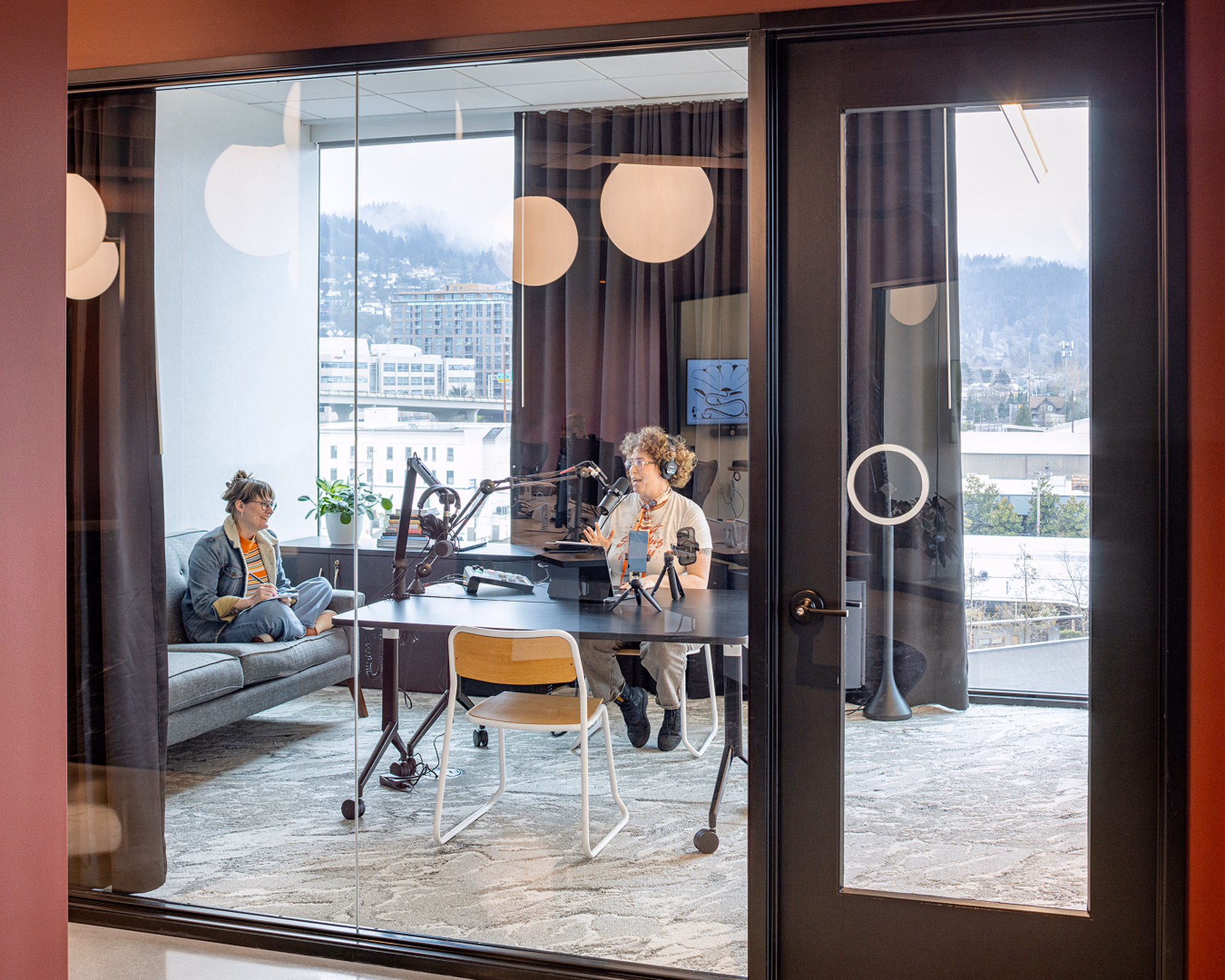 People recording a conversation in a bright creative studio